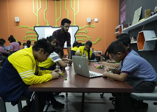 MRIS Charmwood students developing future skills by engaging in hands-on STEM activities, including electronics with a breadboard and building a programmable robot.
